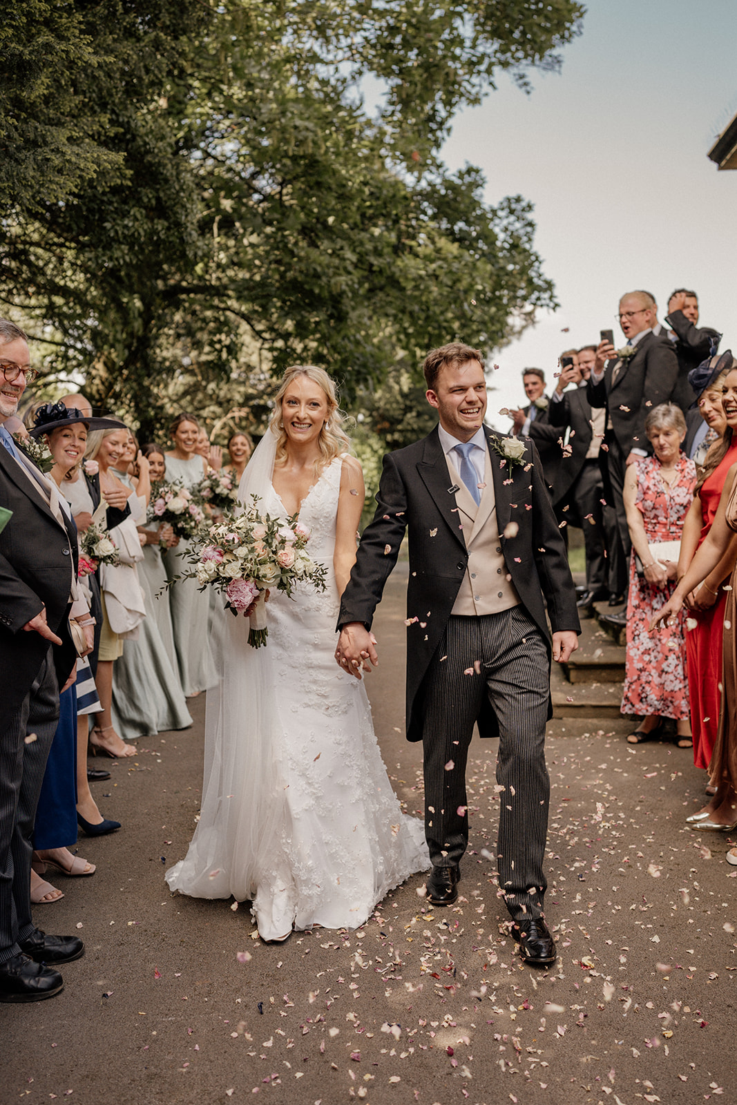 wedding couple showered in confetti captured by midlands photographer